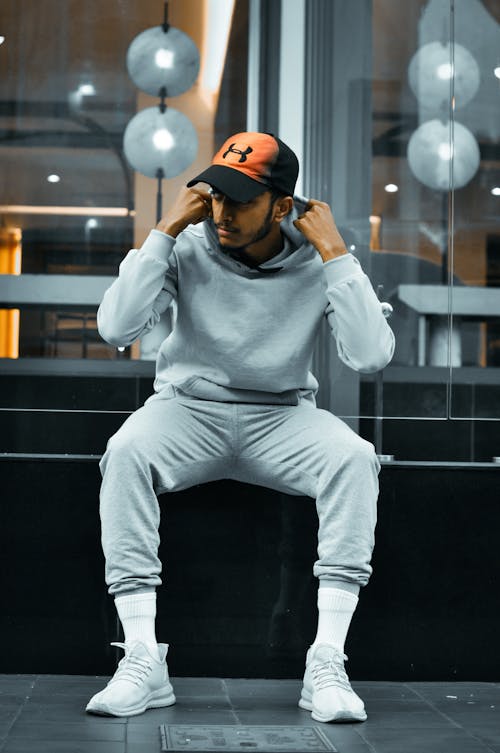 Man in Gray Hoodie Sweater Sitting on a Bench