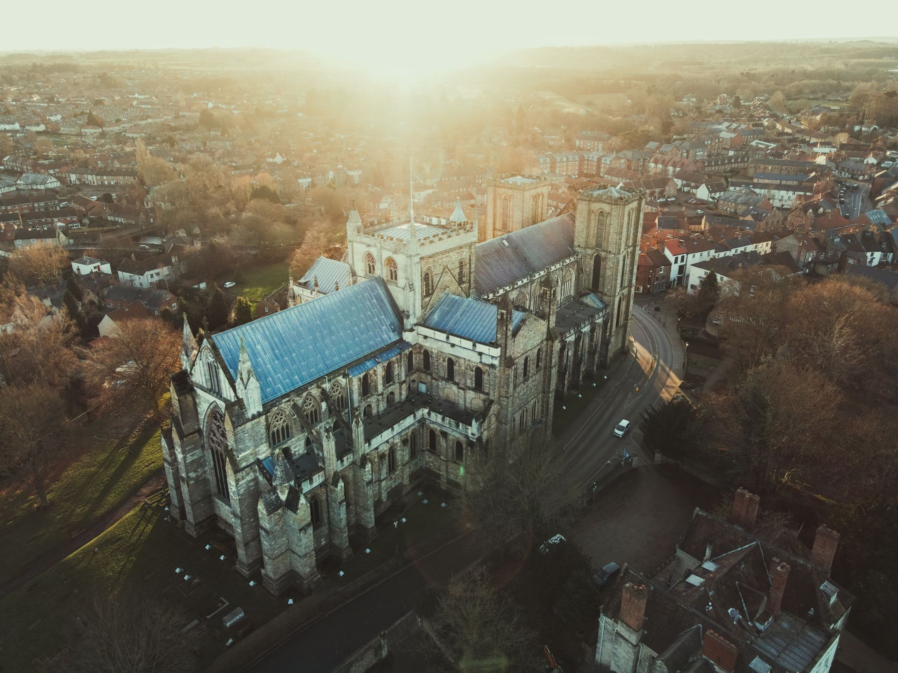 Ripon Cathedral's west front rising above the market square at dusk in North Yorkshire