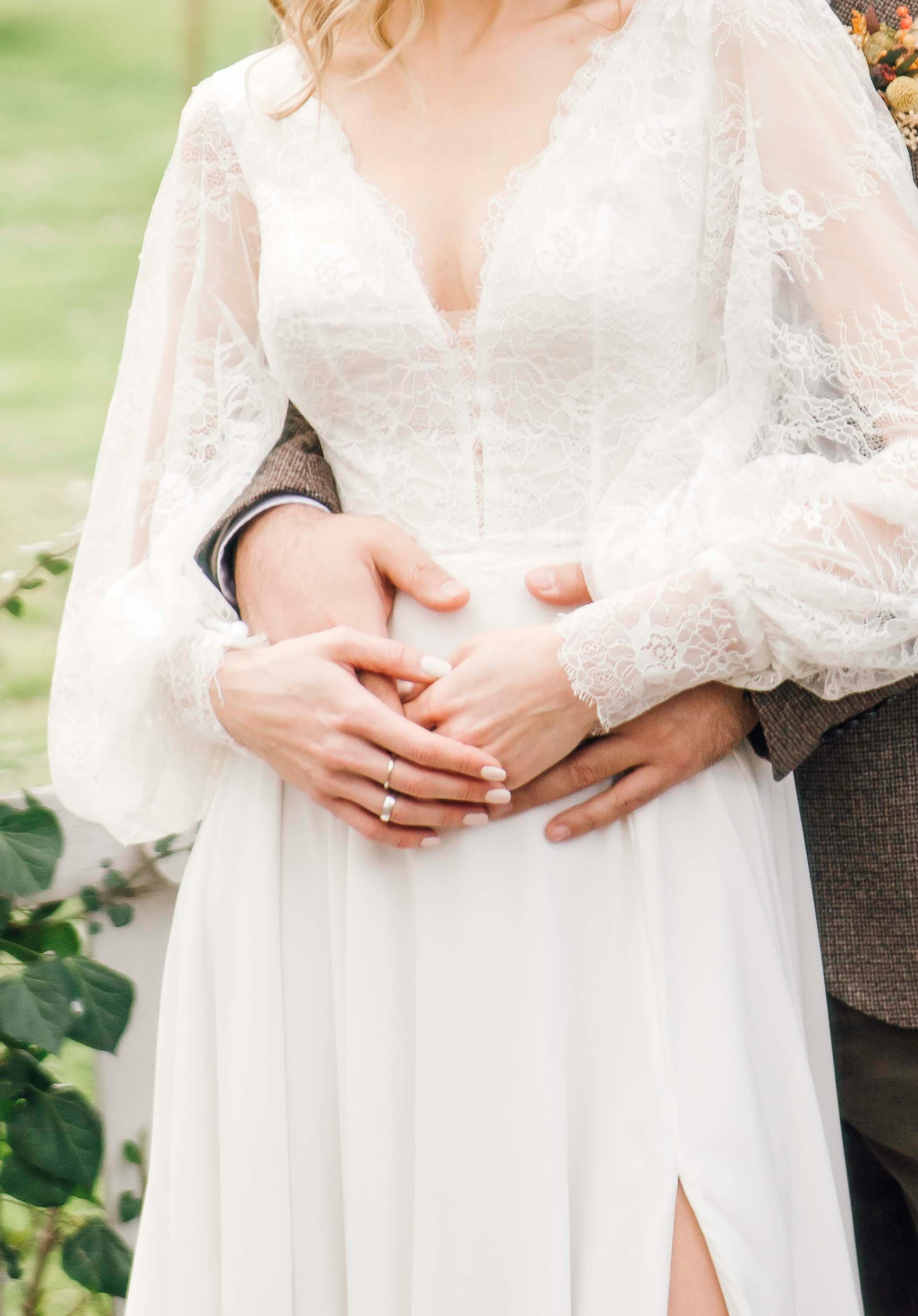 groom hugging a bride from behind