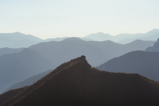 Serene view of mountain ranges with a misty atmosphere at sunrise in Spain, showcasing natural beauty.