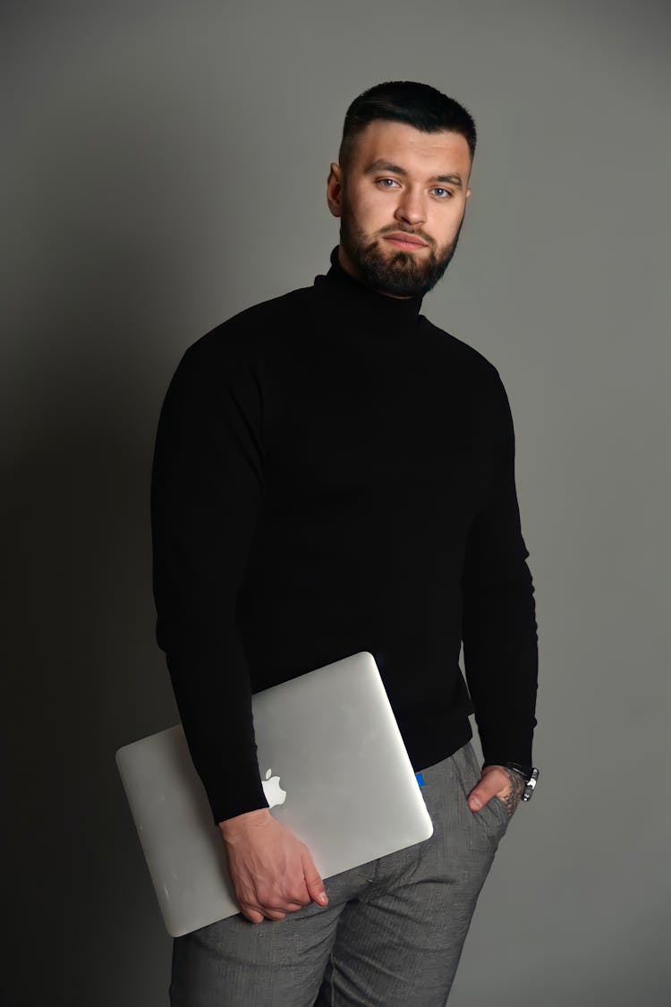 Man In Sweater Holding Laptop