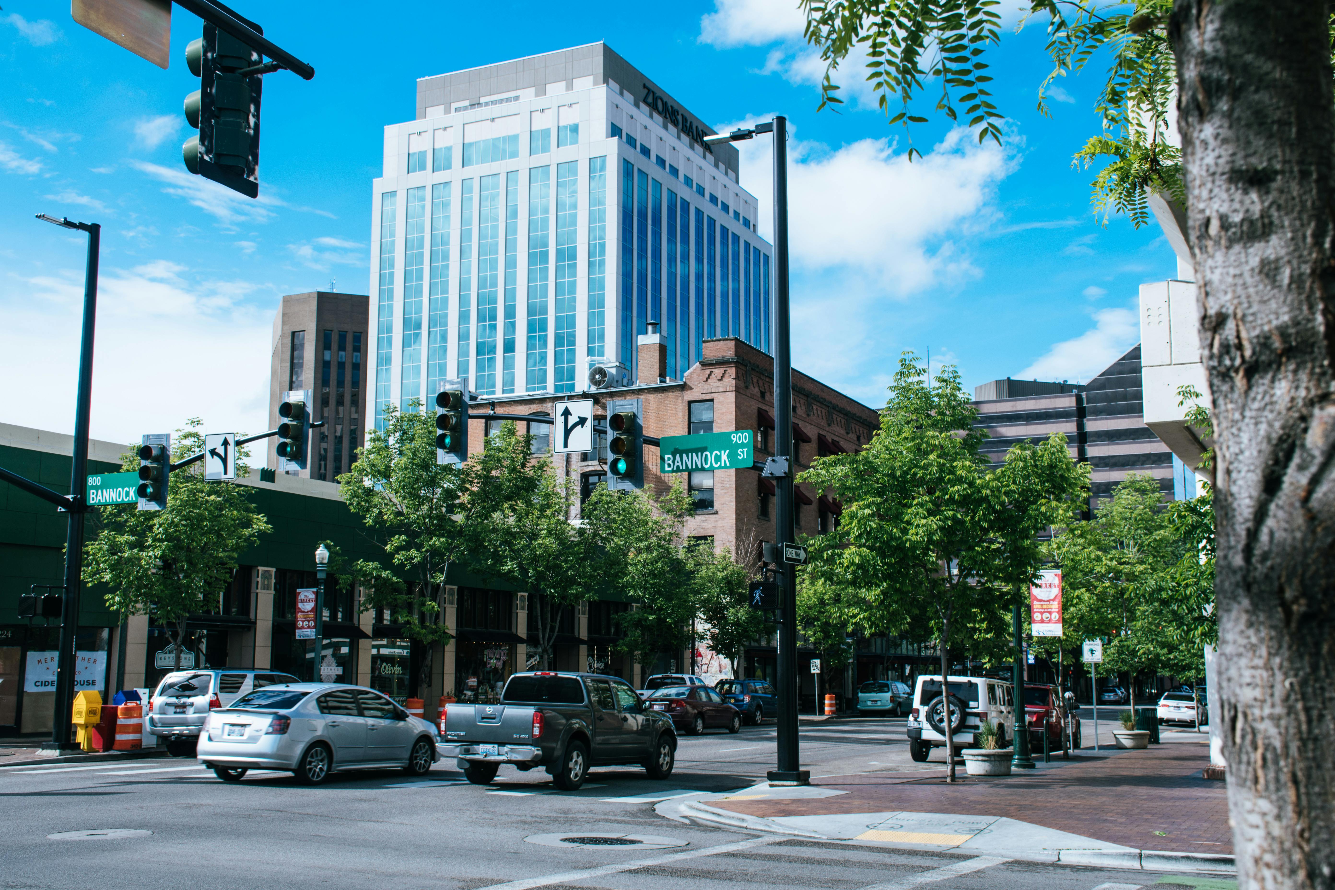 Scenic downtown intersection with skyscrapers and cars, showcasing urban life and architecture.