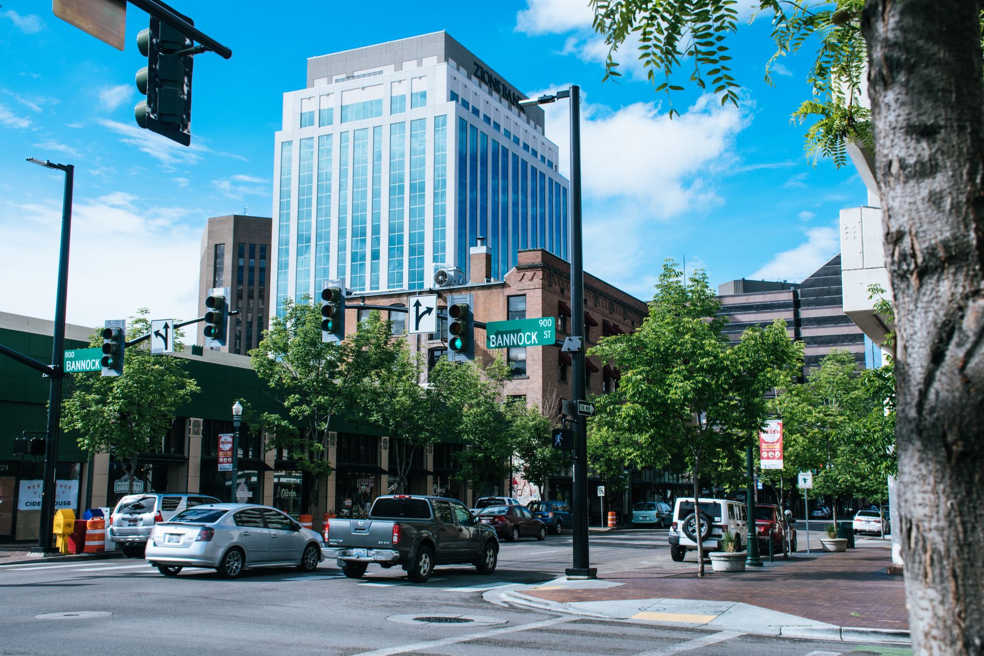 Scenic downtown intersection with skyscrapers and cars, showcasing urban life and architecture.