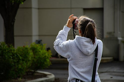 Foto De Uma Garota Segurando Dslr Camer E Tirando Uma Foto