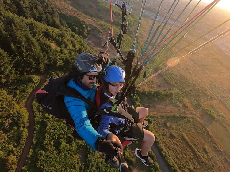 Man Parachute Jumping With Instructor