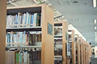 Books on Brown Wooden Shelf