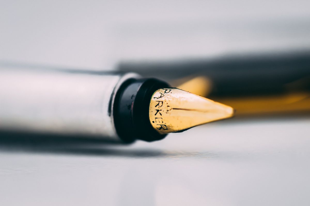 Fountain pen nib resting on paper — photo by Sahil Kharbanda on Pexels