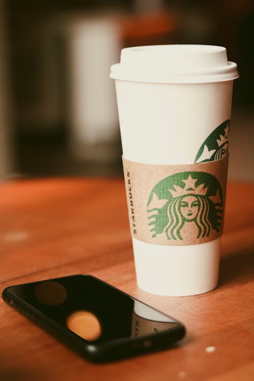 White Starbucks Cup on Brown Wooden Table