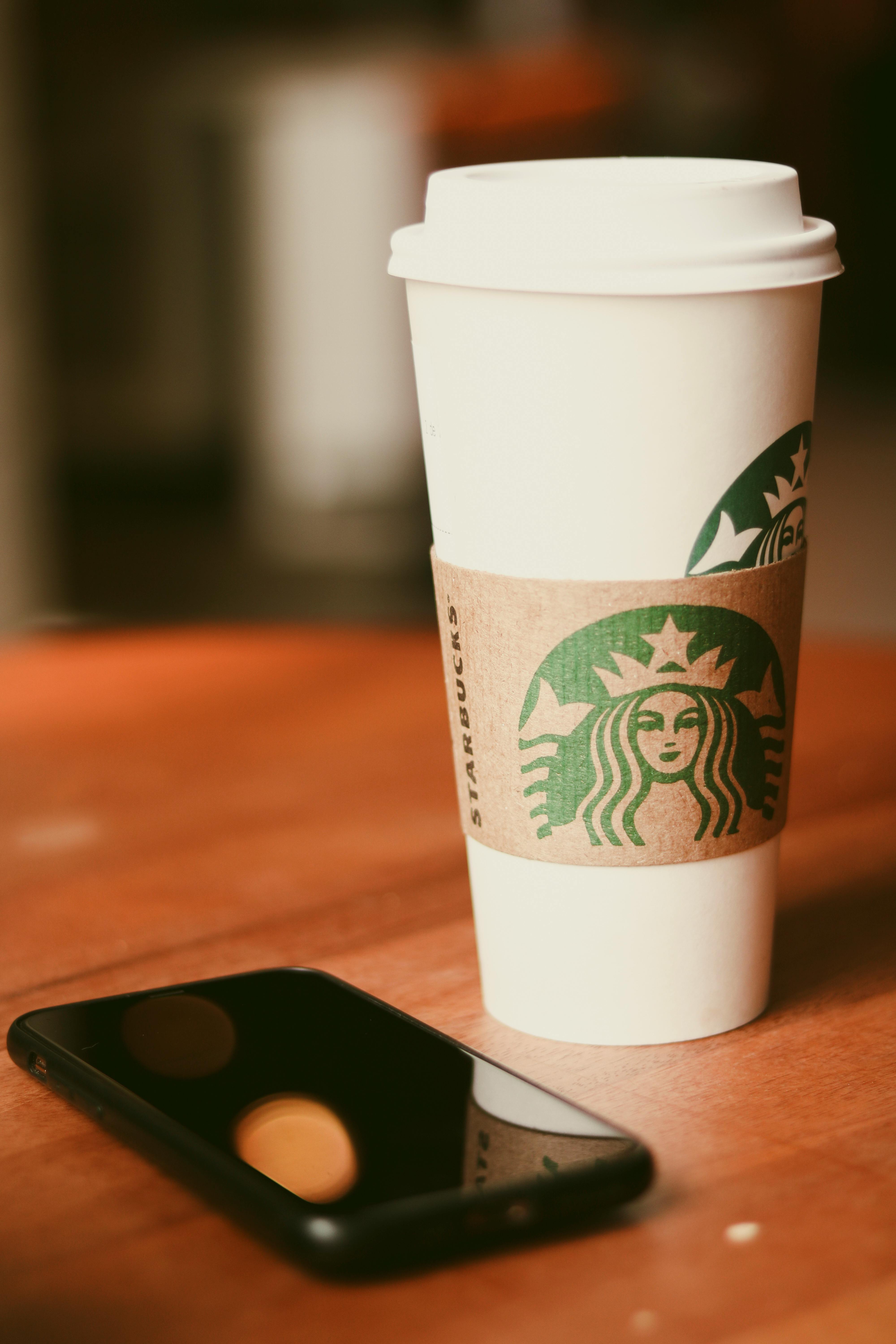 Woman Holding a Starbucks Clear Plastic Cup · Free Stock Photo