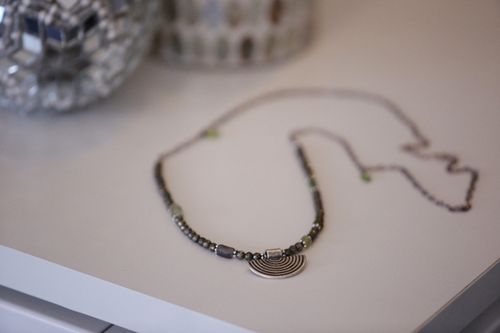 Free Close-up of a stylish beaded necklace with pendant on a white surface. Stock Photo
