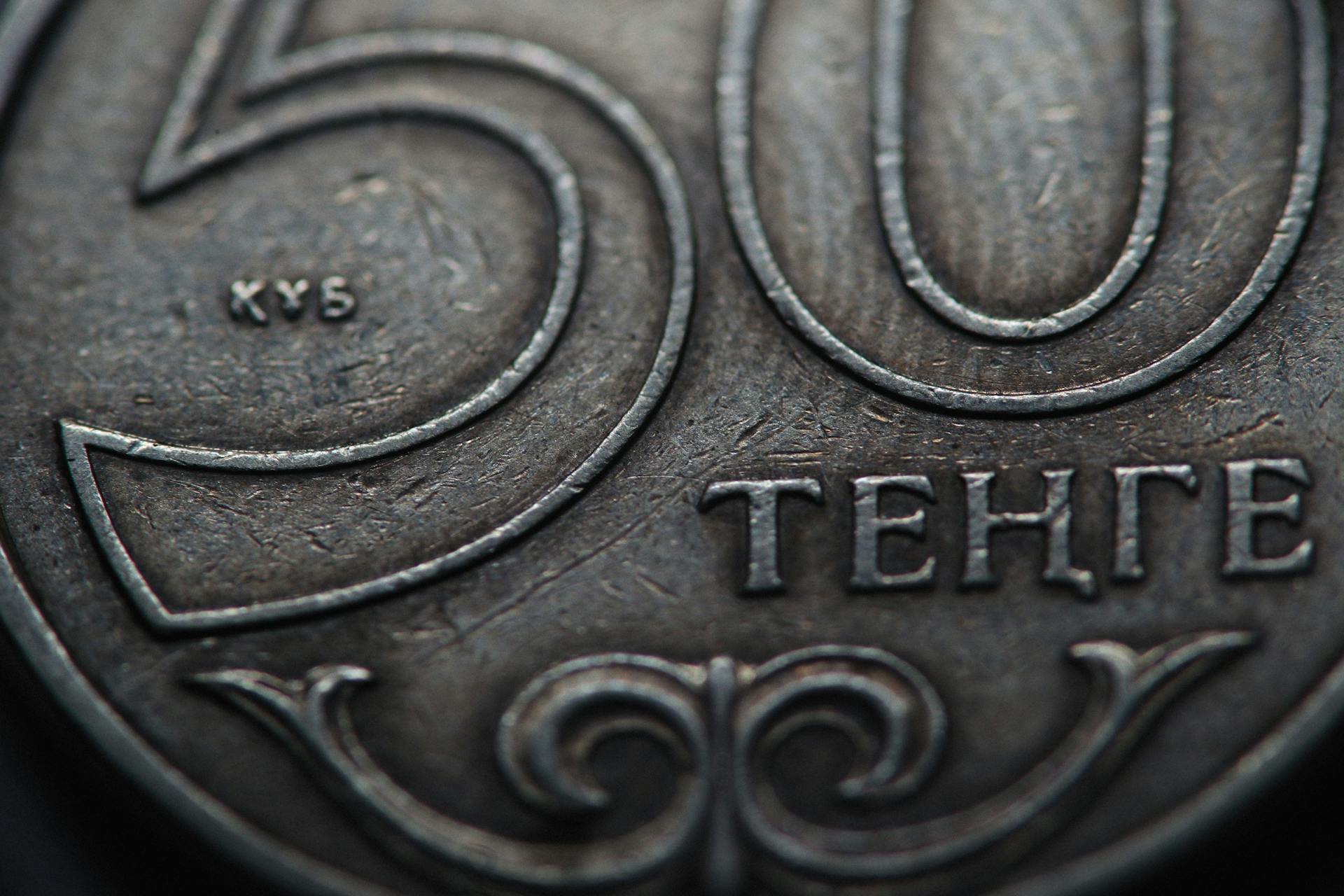 Detailed macro shot of a 50 Tenge coin showcasing intricate designs and text.