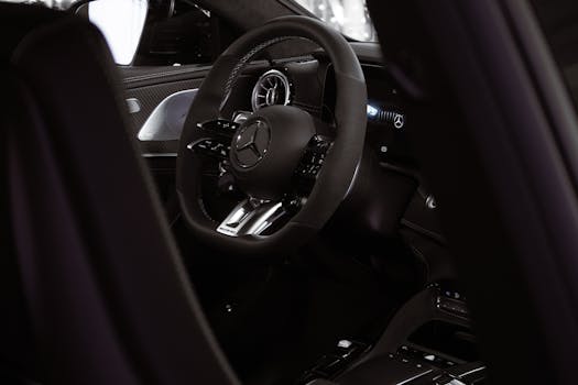 Close-up of a luxury car interior showcasing an elegant steering wheel.