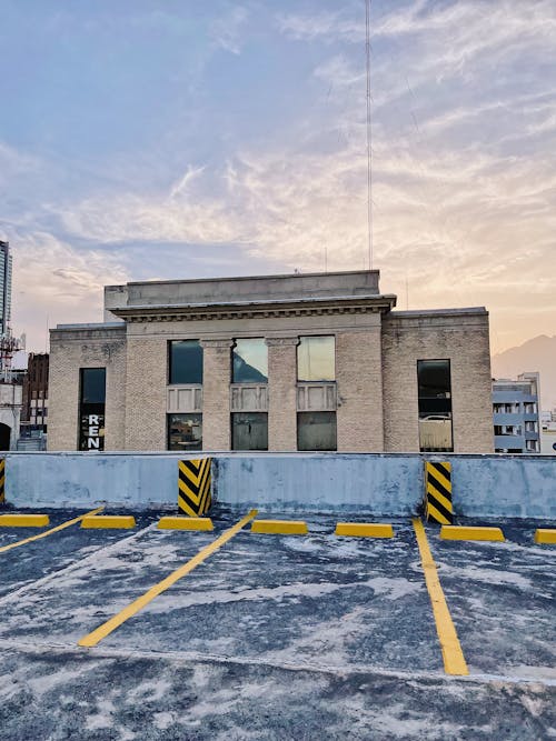 Brown Concrete Building Under White Clouds