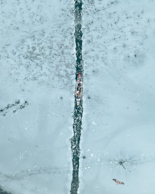 Rowboat on Water Among Ice