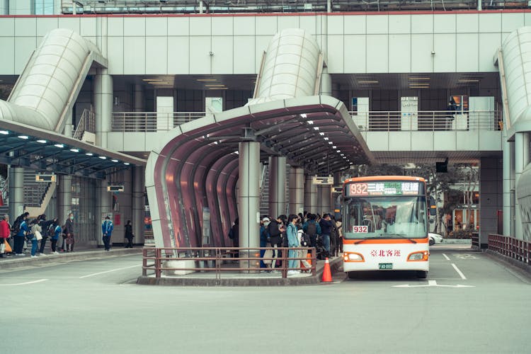 People Standing At A Bus Station