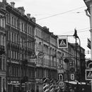 Grayscale Photo of Street Light and Buildings
