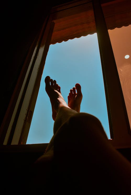 Free A Person's Feet on Window Stock Photo