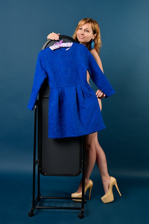 Woman holding a Blue Long Sleeve Dress