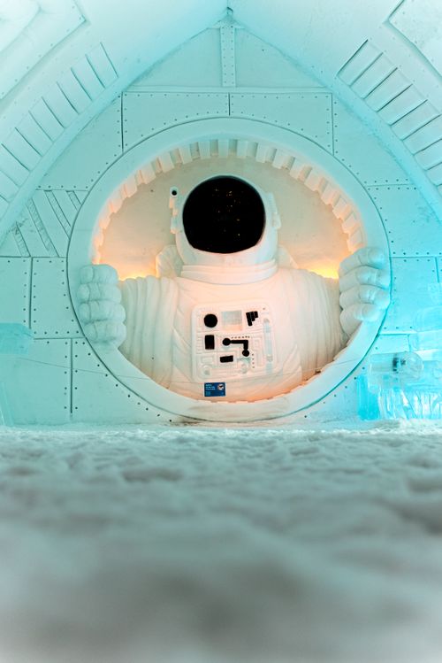 Free A detailed astronaut sculpture crafted from ice displayed in a winter exhibition setting. Stock Photo
