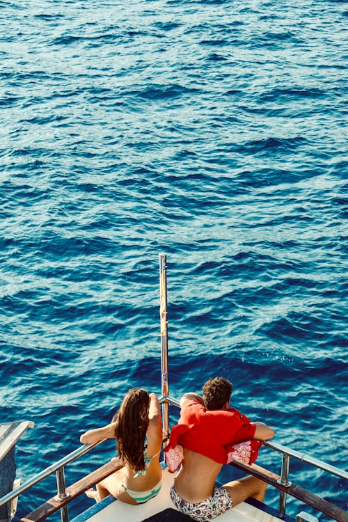 Free Couple sitting at the edge of the Dock  Stock Photo