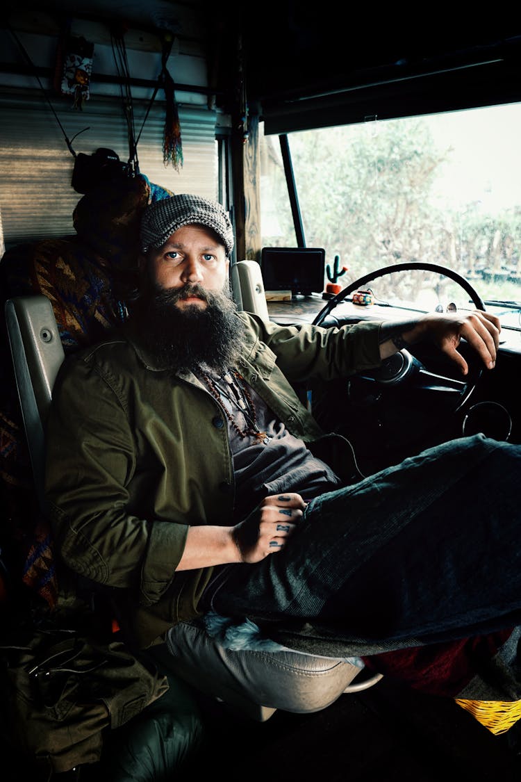 Truck Driver Sitting Behind Steering Wheel In His Cabin