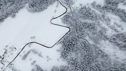 Free Aerial View of Road in the Middle of Snow Covered Ground Stock Photo