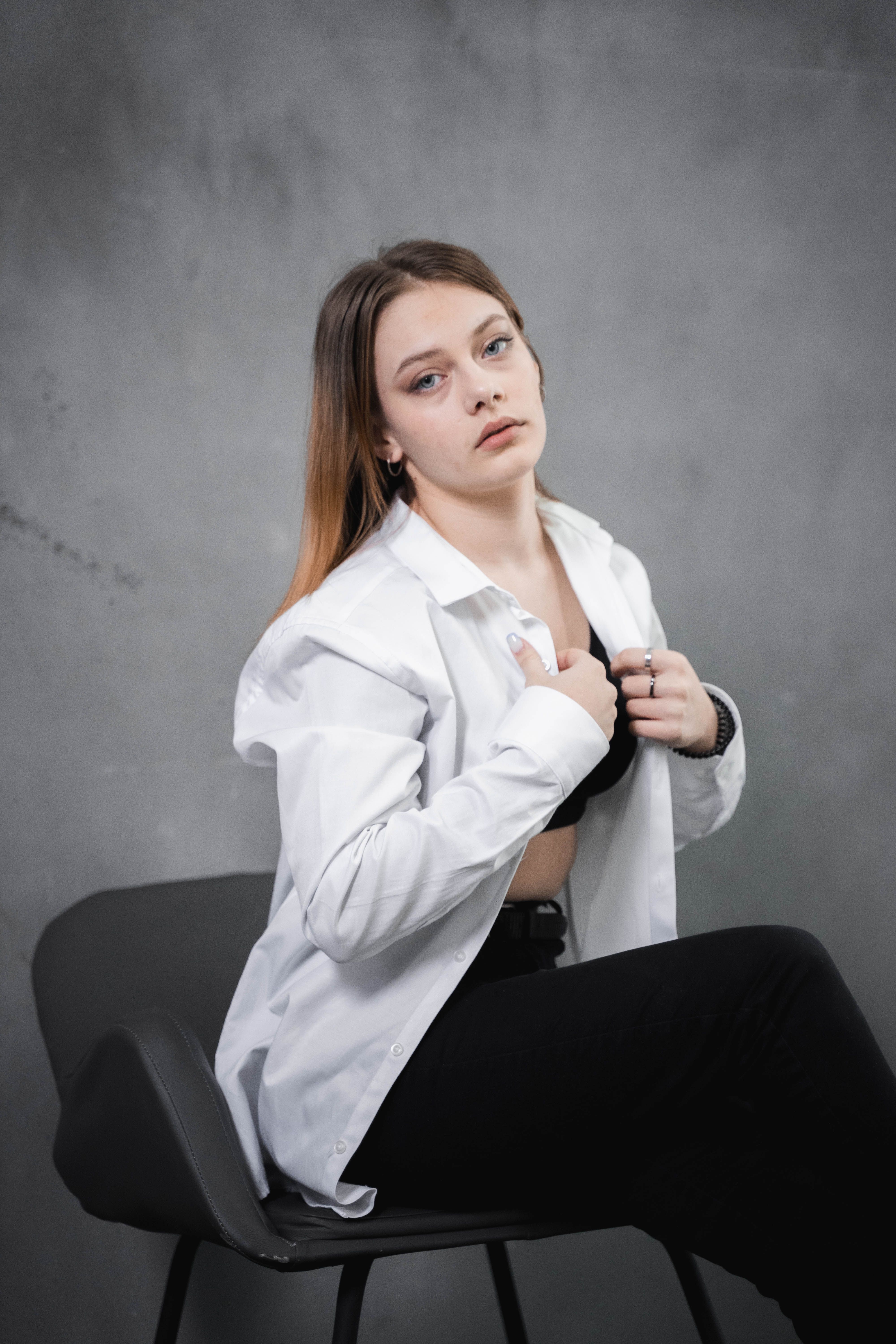 Woman in White Dress Shirt Sitting on a Chair · Free Stock Photo