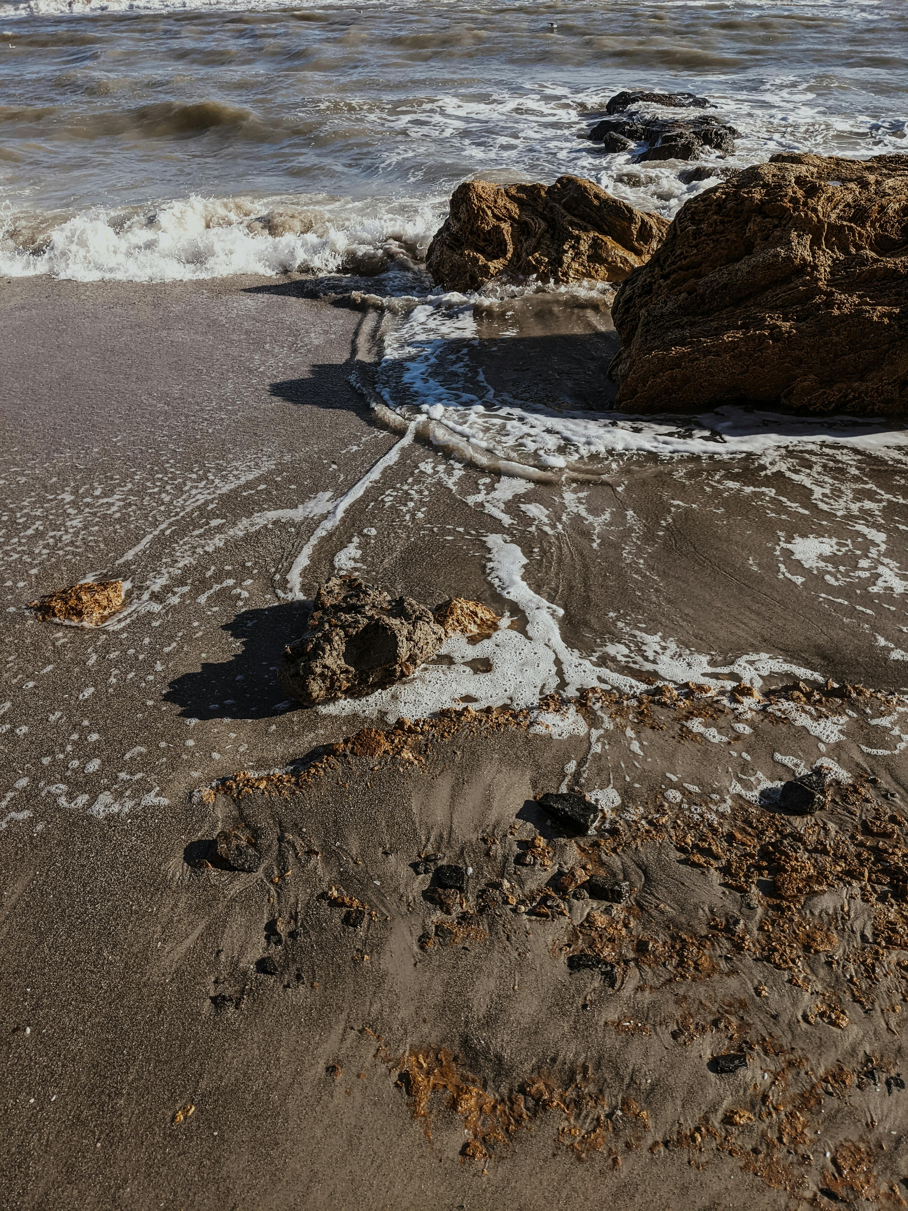 Dramatic coastal scene in Odesa, Ukraine showcasing foamy waves crashing onto rocky beach.