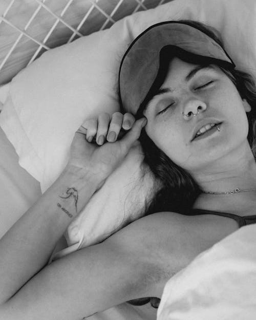 Free Black and White Portrait of Woman Sleeping with Sleeping Mask on Stock Photo
