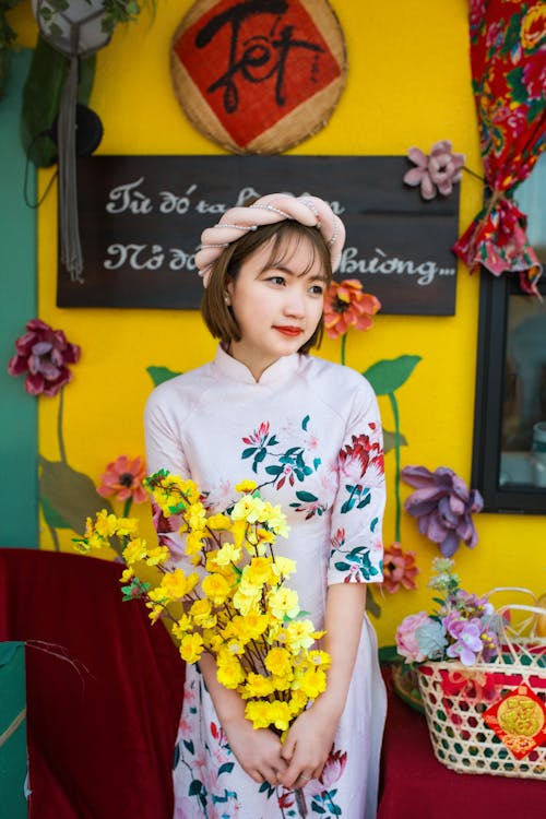 Portrait of Woman in Dress Holding Flowers