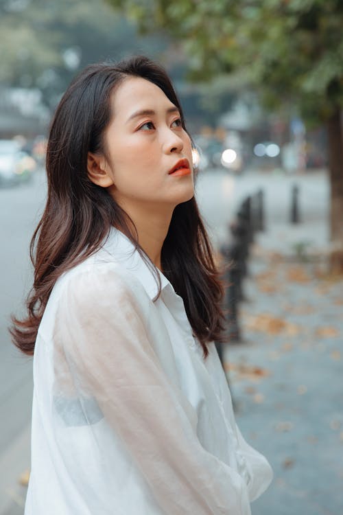 Woman in White Long Sleeves Looking Up