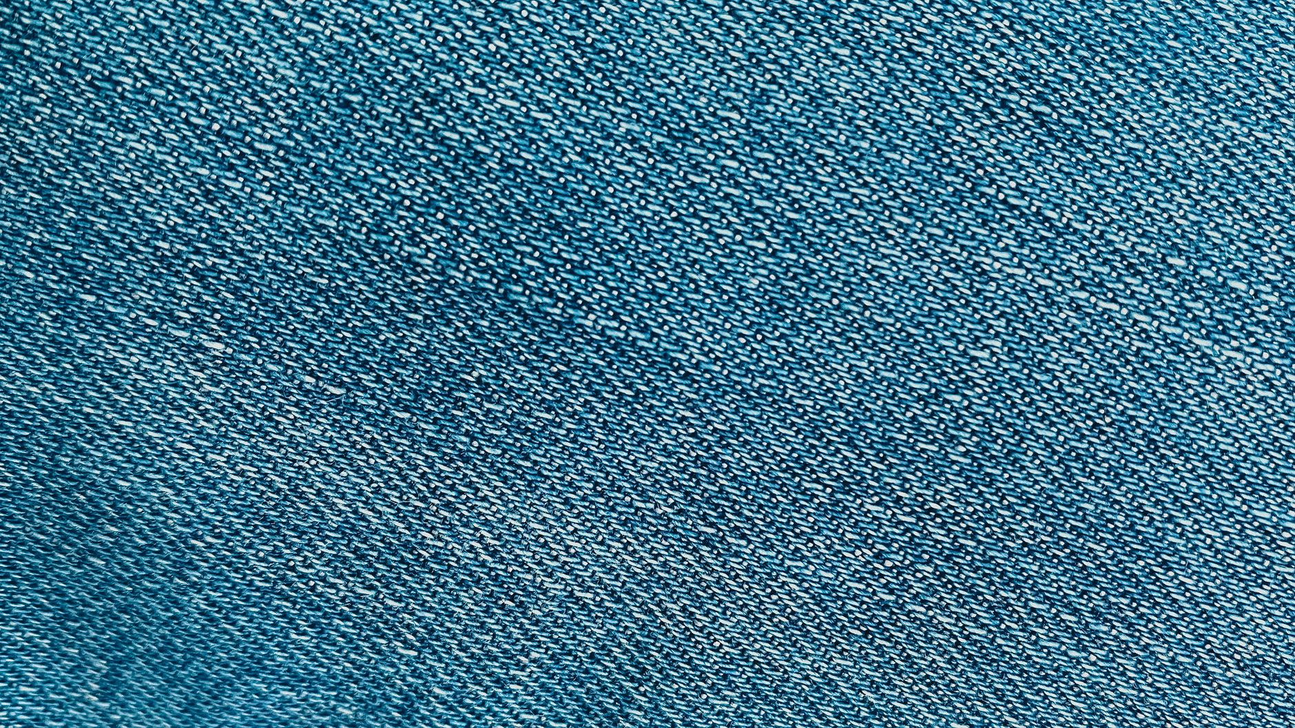 close-up of selvedge denim showing the finished edge with coloured thread