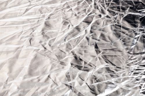 Free Detailed close-up of a crumpled silver surface showcasing unique textures and reflections. Stock Photo