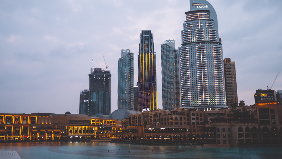 Global Village Dubai at night with diverse country pavilions and lights