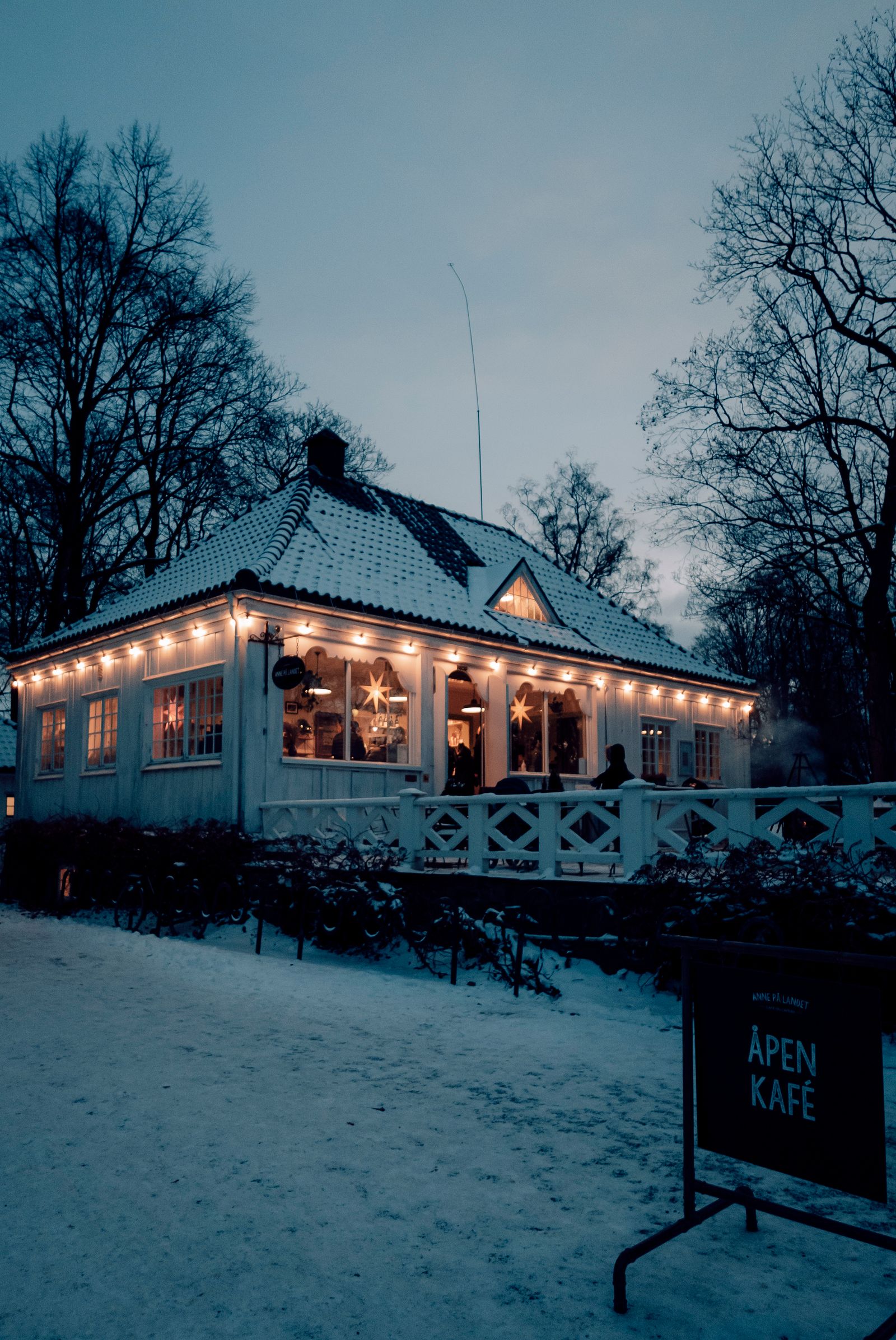 A cozy cabin glowing on a cold winter evening in the mountains