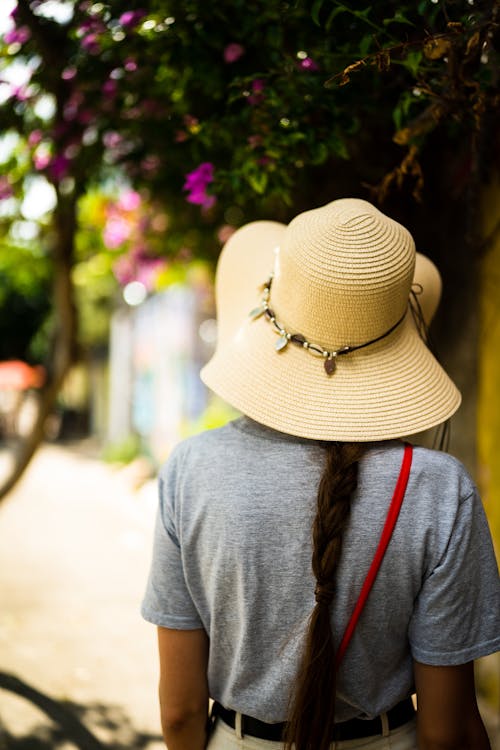 Back View of a Woman in Gray Shirt Wearing Sun Hat