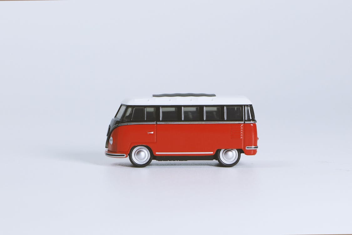 Red Volkswagen T1 Die-cast Toy on White Surface