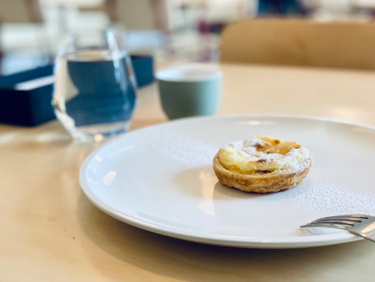 Pastry With Cream On White Plate