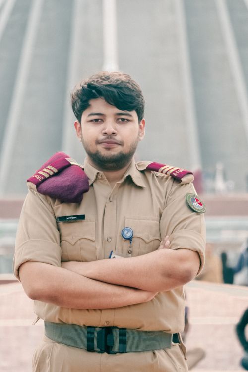 Free Male officer in uniform standing confidently in front of Jatiyo Sriti Shoudho in Dhaka, Bangladesh. Stock Photo