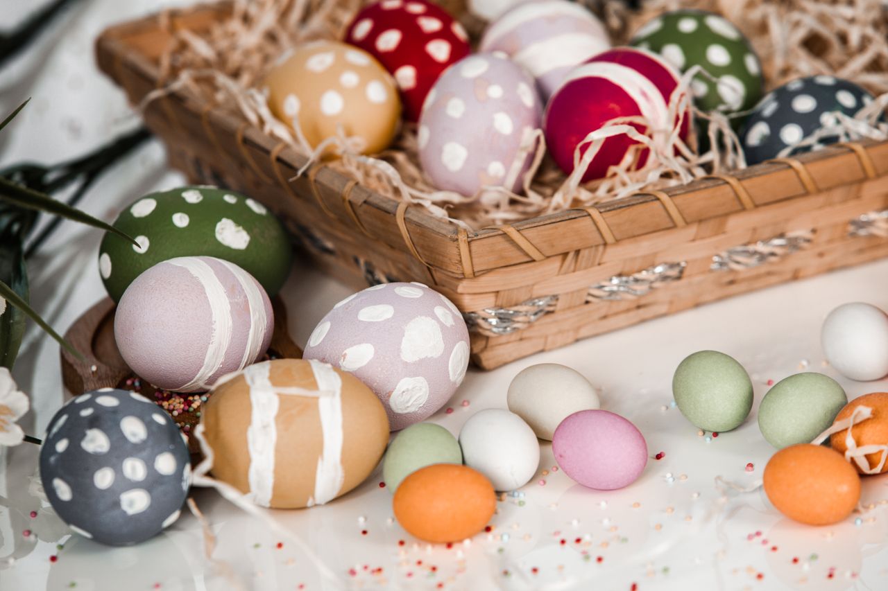 decorative easter eggs arranged in a basket symbolizing traditional ce