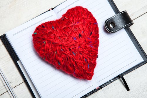 Red Heart Shaped Yarn on White Notebook