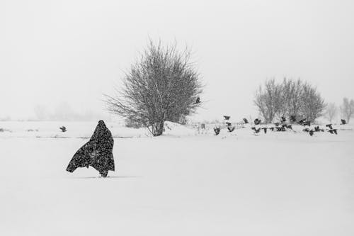 Woman in a Burkha Walking in a Snow