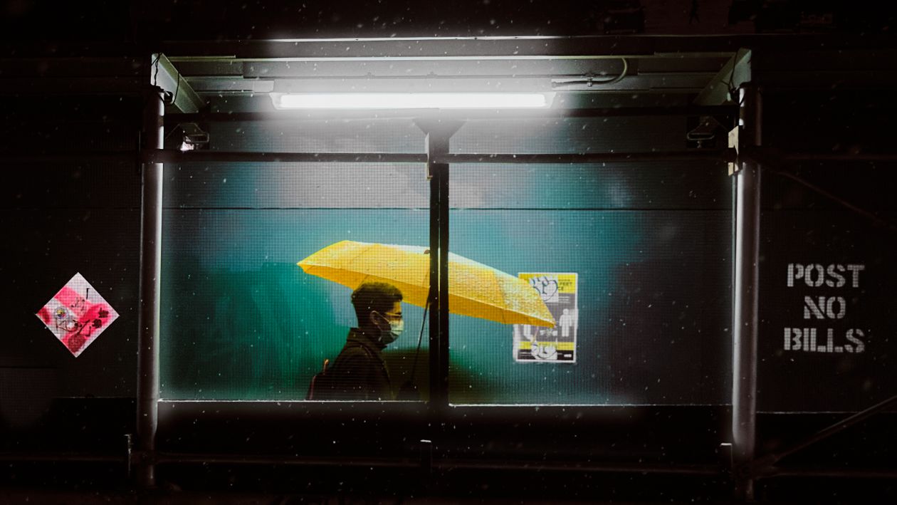A Man Holding a Yellow Umbrella · Free Stock Photo