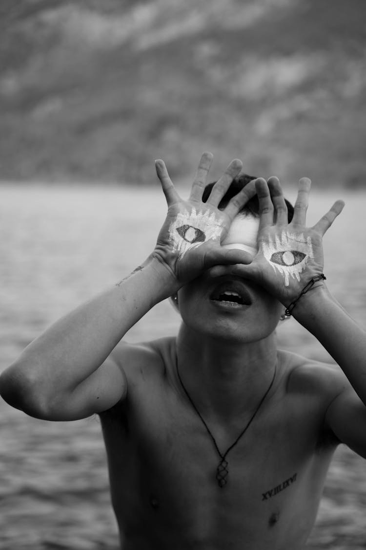 Undressed Man Covering Eyes With Painted Hands Pretending Open Eyes