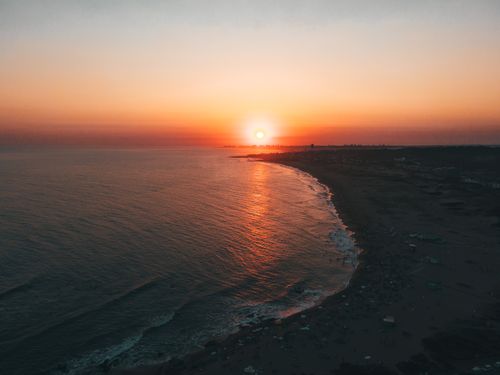 Free A breathtaking aerial view of a sunset over Punta del Este beach, casting warm hues on the ocean waves. Stock Photo