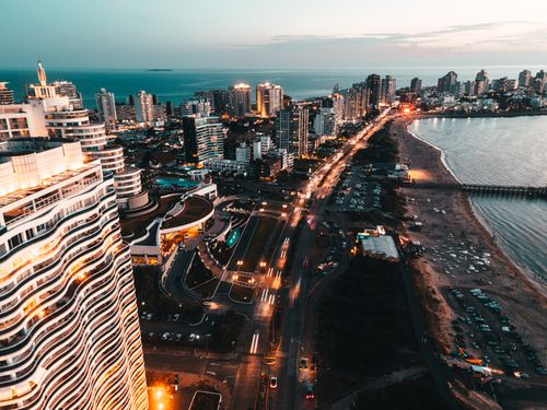 Free A breathtaking aerial shot of Punta del Este showcasing the waterfront and vibrant cityscape at twilight. Stock Photo