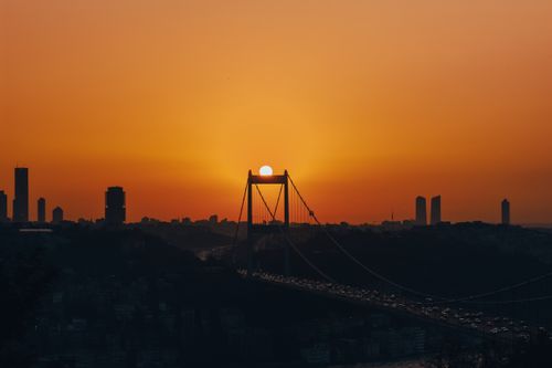 Free Silhouette of İstanbul skyline with Bosphorus Bridge at sunset and vibrant orange sky. Stock Photo