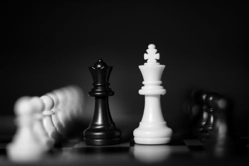 Free Black and white close-up of chess pieces in a strategic arrangement. Stock Photo