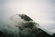 Green and Black Mountain Under White Clouds