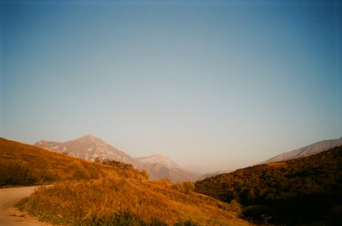 Free A serene view of mountains and hills under a clear blue sky during autumn. Stock Photo